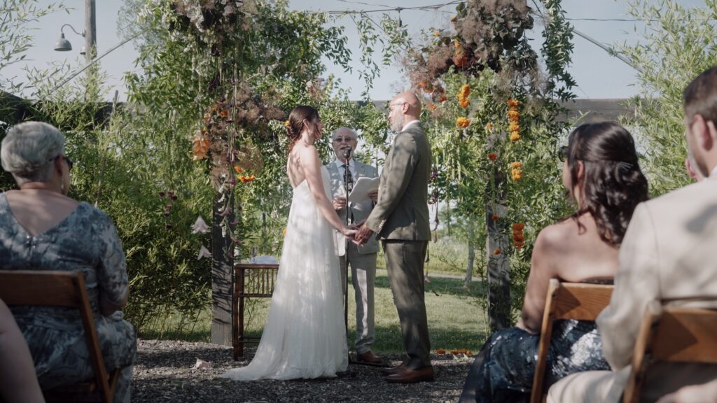 Couple stand under their Chuppah during their Jewish Wedding Ceremony