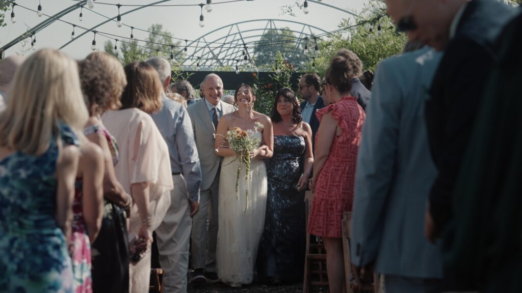 Hudson Valley Bride walks down the Aisle with her parents at Audrey's Farmhouse